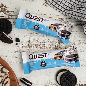 Quest Nutrition Dipped Chocolate Chip Cookie Dough Protein Bars, High Protein, Low Carb, Gluten Free, Keto Friendly, 12 Count - image of 2 dipped cookies and cream bars on a table