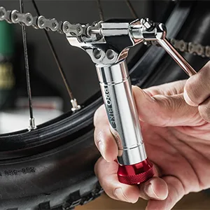 PRO BIKE TOOL Universal Chain Tool with Spare Pushing pin - Compatible with 8-12 Speed Chains Chain Splitter - Silver - Red chain tool being used with chain