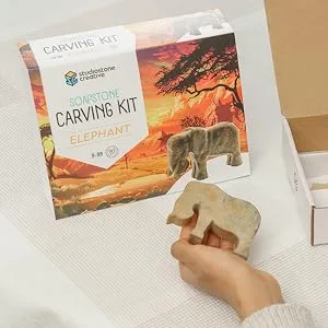 Studiostone Creative Elephant Soapstone Sculpture Stone Carving DIY Arts Crafts Kit Kids Adults - Kid holding raw stone in front of soapstone elephant carving kit