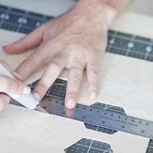 Fiskars Craft Supplies: Self Healing Cutting Mat for Crafts, Sewing, and Quilting Projects, 24x36 (12-83727097J) , Gray Home - hand measuring with a ruler and self healing mat