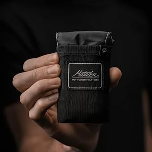 Matador Pocket Blanket Black Regular (Seats 2-4) - Hand holding pocket blanket