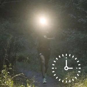 Nitecore NU25 400 USB-C Rechargeable Headlamp, Lightweight, Dual Beam, with Red Lighting for Hiking, Climbing, and Camping, with Lumentac Organizer - person running on a trail while wearing a headlamp