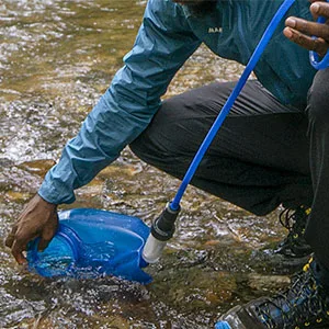 CamelBak Reservoir Filter Kit Filtered by LifeStraw - CamelBak hydration bladder filtered by LifeStraw being filled in a stream.