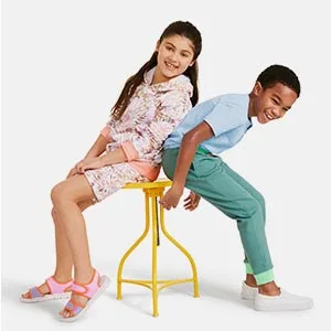 Lands' End School Uniform Kids Active Track Pants 8 Black - Two children smile while both try to fit on the same stool.