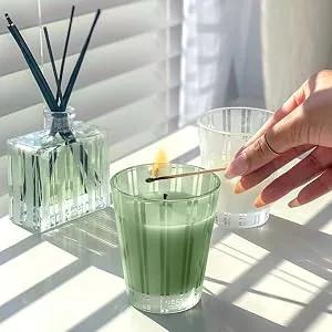 NEST New York Bamboo Scented Classic Candle Bamboo Classic Candle - Someone lighting a Classic Candle