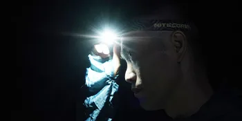 Nitecore NU33 Rechargeable Headlamp, 700 Lumen USB-C White, Red and Reading Lights, with Lumen Cable Organizer - man wearing a Nitecore headlamp