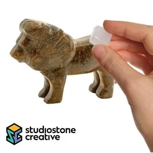 STUDIOSTONE CREATIVE Lion and Elephant Soapstone Sculpture Stone Carving DIY Arts Crafts Kit Kids Adults - Hand holding wax up to soapstone lion sculpture