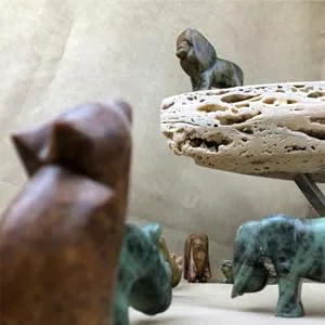 STUDIOSTONE CREATIVE Lion and Elephant Soapstone Sculpture Stone Carving DIY Arts Crafts Kit Kids Adults - Soapstone lion on rock above other soapstone animal sculptures