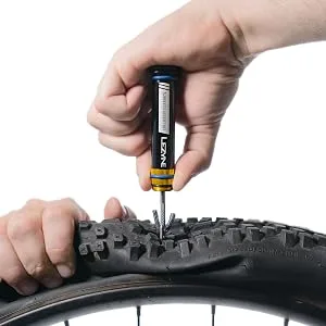 LEZYNE Dual Insert Bicycle Kit, Handlebar End Cap Multi-Tools, Includes Tubeless Tire Repair Kit with 5 Tire Strips & Tool Insert Kit, Bike Bar Plugs, Large - LEZYNE Tubeless Tire Repair Tool Fixing a Punctured Bike Tire