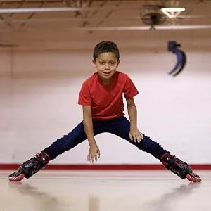 Roller Derby ION 7.2 Inline Skates with Aluminum Frames and Adjustable Sizing for Growing feet Small (11-1) - Boy skating at the rink