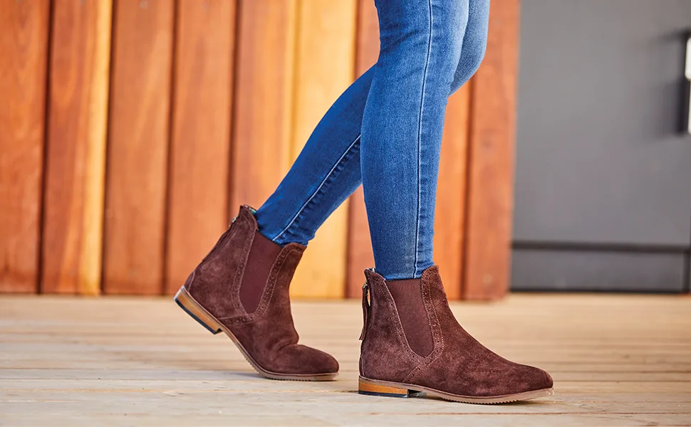Dublin Kalmar Sd Paddock Boots 8 Stone - Cropped image of a model from the knees down in jeans and the paddock boots walking on wooden floor