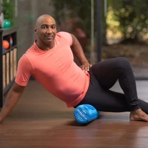 OPTP PRO-Roller Soft Foam Roller - Pink 36" x 6" PSFR36 - Man on foam roller in home setting