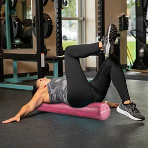OPTP PRO-Roller Soft Foam Roller - Pink 36" x 6" PSFR36 - woman helping man with foam roller in gym setting