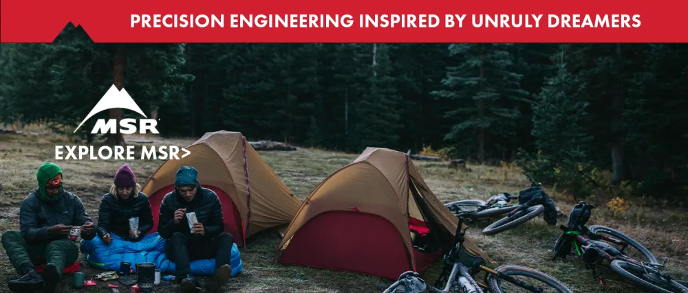 MSR Striker CX 320 Avalanche Probe - 3 people eating a camp meal in the woods