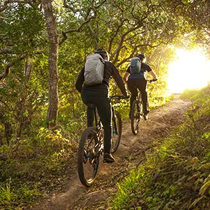CamelBak M.U.L.E. 12 Mountain Biking Hydration Backpack - Easy Refilling Hydration Backpack - Magnetic Tube Trap 100oz Black - Two bike riders wearing cycling hydration packs.