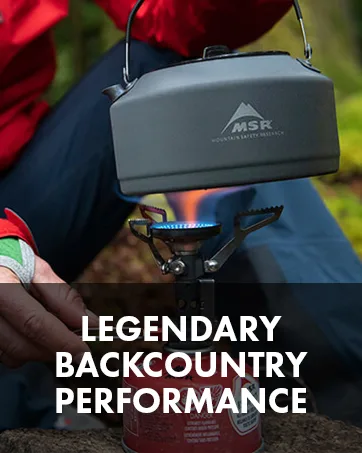 MSR MiniWorks EX Backountry Water Filter - Person putting a kettle on a backpacking stove