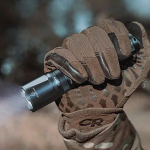 Fenix TK20R v2.0 Rechargeable Tactical Flashlight, 3000 Lumen Long Throw USB-C Tac Light, with LumenTac Organizer - hand holding the TK20R v2.0