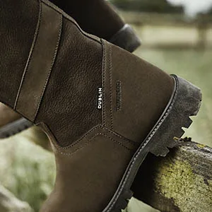 Dublin Kennet Boots 8.5 Chocolate - Close up side view of the rugged sole of the boot on a fence rail