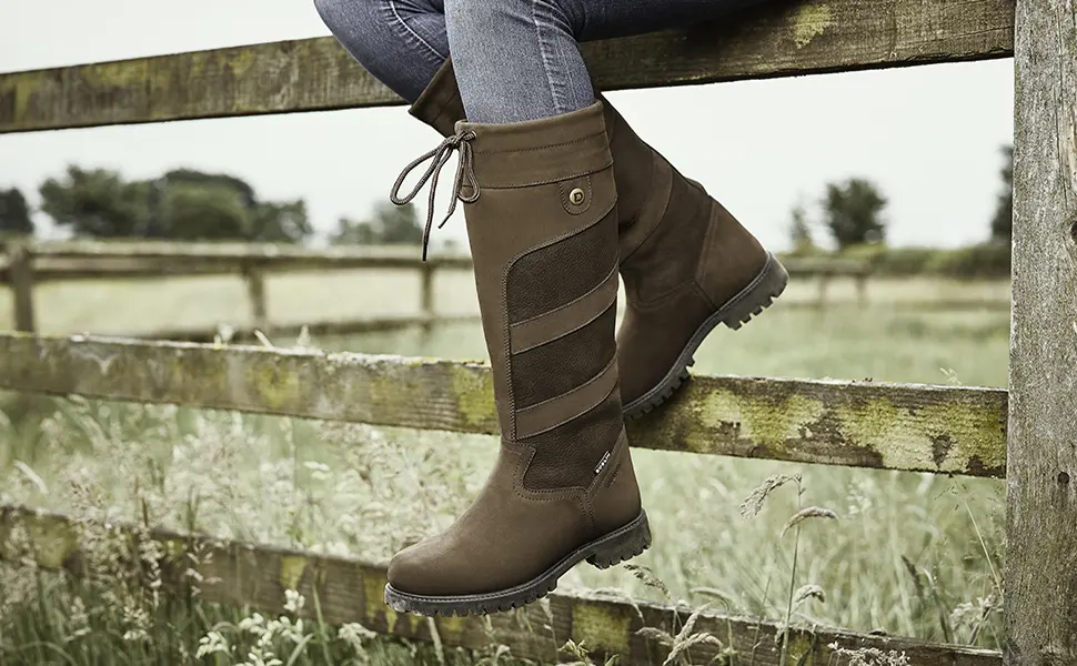 Dublin Kennet Boots 8.5 Chocolate - Image of a person sitting on a split rail fence cropped at the knees showing the boots