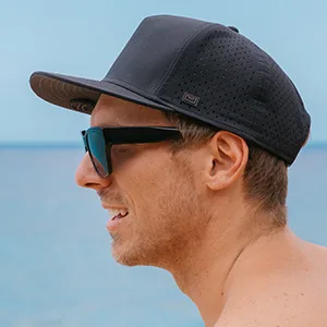 melin A-Game Hydro, Performance Snapback Hat, Water-Resistant Baseball Cap for Men & Women Black Medium-Large - man wearing hat