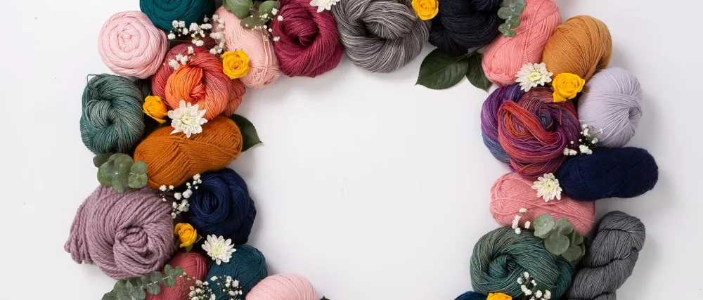 Knit Picks Premium Knitting Chart Keeper (Black) - A wreath made from as assortment of Knit Pick yarns