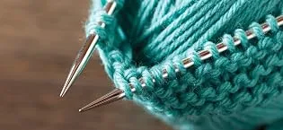 Knit Picks Premium Knitting Chart Keeper (Black) - nickel plated needles displayed with knitting and yarn