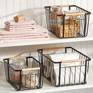mDesign Plastic First Aid Kit Storage Box with Clear Top Lid for Bathroom  Kitchen  Cabinet  Closet  Drawer - Organizes Medicine  Ointments  Adhesive Bandages  Dental  8 Divided Sections - Clear - black wire baskets holding glass jars and toilet paper, towels on white shelves with white wood wall