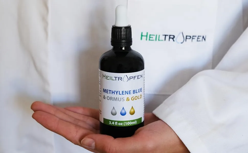 Methylene Blue & Ormus & Gold 3.4 Fl Oz - 100 ml | Ultra High Purity | with 10 ppm Colloidal Gold 24K | Glass Bottle | Third-Party Tested | Heiltropfen  - Hand holding Heiltropfen Ormus Colloidal Gold Methylene Blue Solution dropper for research use.