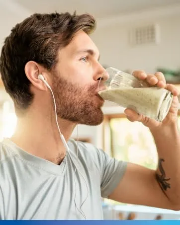 Biotics Research Chlorocaps Chlorophyllins Vitamins SOD & Catalase Good Source of Magnesium 90 Caps - Man drinking a nutrient-rich supplement, promoting health and an active lifestyle