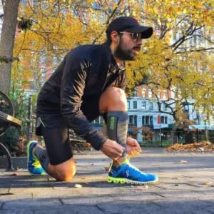 Featherweight Compression Leg Sleeves - Relieve Shin Splints  Calf Strains Large Heather Grey - Guy tying shoe while wearing featherweight leg sleeves