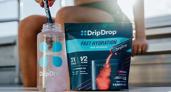 DripDrop Hydration Packets - Bold Variety Pack - Single Serve Electrolytes Powder Drink Mix - Watermelon Berry Lemon Orange - Non-GMO Gluten Free Vegan - 80 Sticks - Pack of DripDrop and pouring it into water bottle