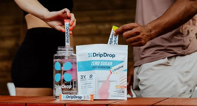 DripDrop Sugar Free Hydration Packets - Zero Classic Variety Pack - Single Serve Electrolytes Powder Drink Mix - Lemon Lime Watermelon Peach Passion Fruit - Non-GMO Gluten Free Vegan - 32 Sticks Classic Variety Pack 32  - Pack of DripDrop and pouring it into water bottle