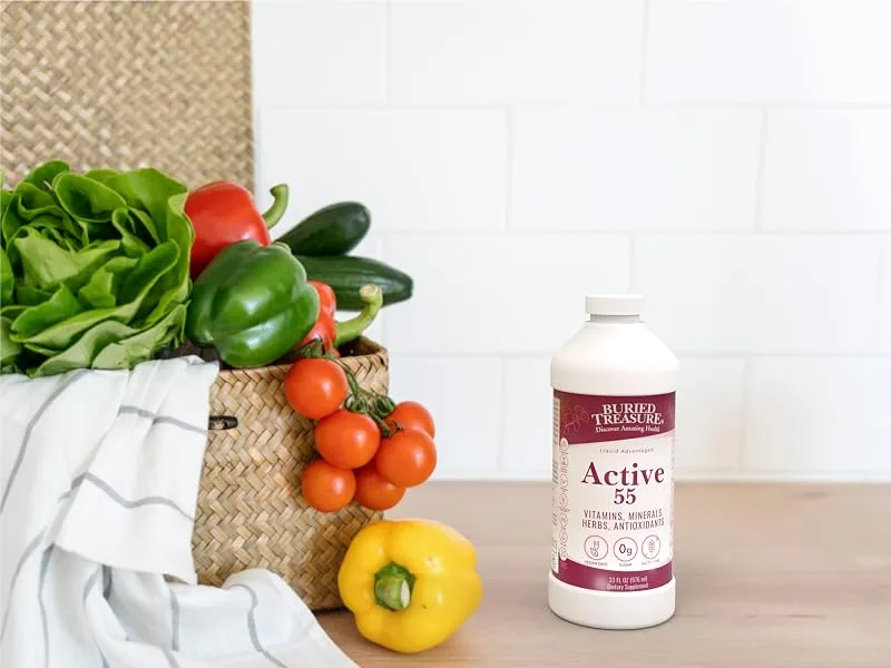Buried Treasure Active 55 Plus - 32 serv Liquid Multivitamin for Seniors Vegan Sugar-Free Natural Immune Support Vitamins & Super-Foods Blend - Active 55 Plus supplement on the counter with multiple fruits and vegetables.