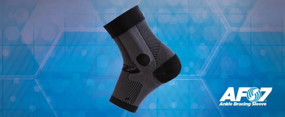 OrthoSleeve Compression Ankle Brace AF7 for inversion sprains  weak ankles  instability and Achilles tendonitis (Large  Black  Left Foot) Large Black Left Foot - The OrthoSleeve AF7 Ankle Bracing Sleeve on a blue background