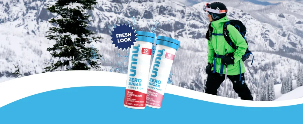 Nuun Zero Sugar Hydration Electrolyte Tablets - Sodium Potassium Chloride Calcium Magnesium Light & Delicious Fruit Flavors No Sugar Gluten Free Vegan Raspberry Lemonade (80 Servings Total) Raspberry Lemonade 80 Co  - woman on a snowy mountain with nuun zero tablets