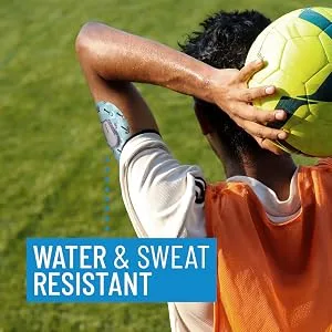 Dexcom G6 Adhesive Patch  Water Resistant  Strong Adhesive Patches.   (Mix Boy) - Man throwing soccer ball with G6 adhesive tape on arm. Water and sweat resistant.