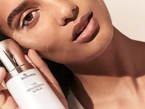 SkinMedica TNS Advanced+ Serum  1 Oz - model holding TNS Advanced +