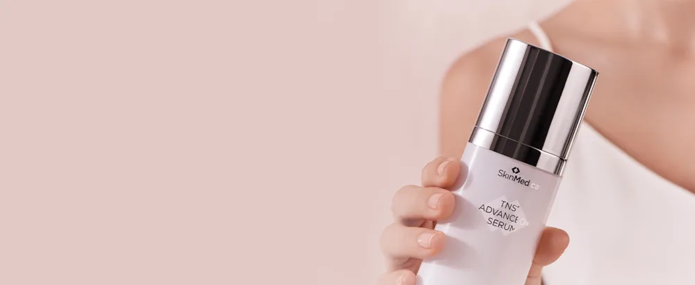 SkinMedica TNS Advanced+ Serum  1 Oz - TNS advanced+ with model holding bottle