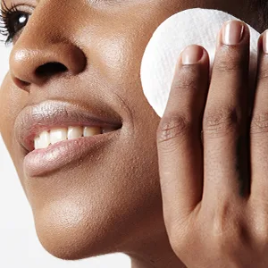 CONTROL CORRECTIVE Complexion Treatment Pads - Exfoliate Pores  Eliminate Impurities  Pre-Moistened Woven Pads Smooth & Tone Complexion  Clears Breakouts  Smooths Skin  Peel Discoloration  Brightens - Woman Close Up with Pad