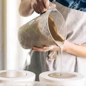 Penguin Pottery - Sodium Silicate Solution - Deflocculant - 16 oz - image of potter pouring liquid clay slip into a mold