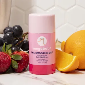 Megababe Daily Deodorant - The Smoothie Deo with Fruit Enzymes | Aluminum-Free  All Natural | 2.6 oz - Smoothie deodorant surrounded by strawberries, oranges, and grapes.