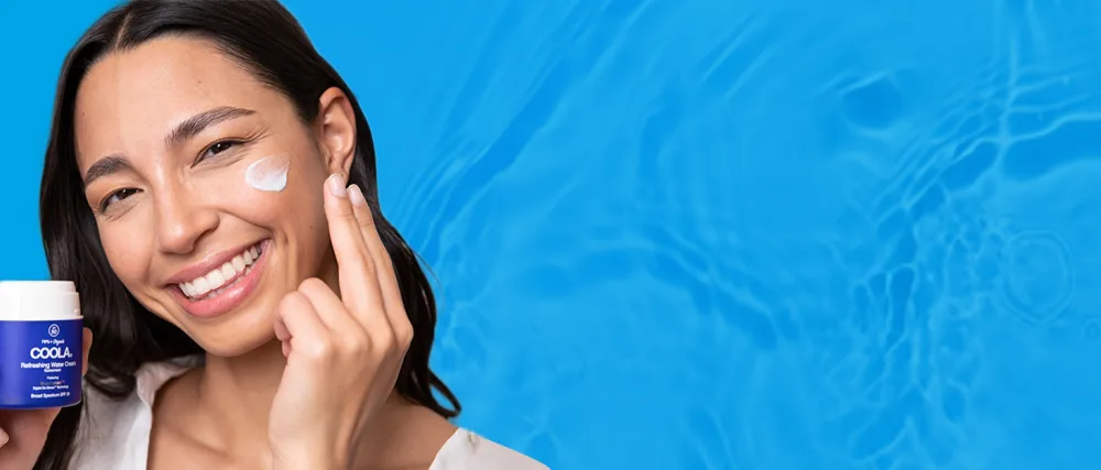 COOLA Organic Refreshing Water Stick Face Moisturizer with SPF 50  Dermatologist Tested Face Sunscreen with Plant-Derived BlueScreen Digital De-Stress Technology  0.8 Oz - Woman using coola refreshing cream on her face on water background