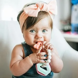 Nuby Chewy Charms Silicone Teether with Coral Unicorn  1 Count (Pack of 1) Unicorn 1 Count (Pack of 1) - baby with teether