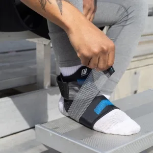 Ankle Brace for Women and Man Ankle Compression Sleeve Ankle Support with Adjustable Compression Strap for Sprained Ankle Injury Recovery and More! (Small) Small (1 Count) - Man adjusting the compression strap on the BODYPROX ankle brace