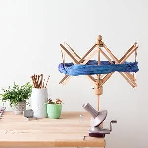 Knit Picks Blocking Mats for Knitting and Crochet Pack of 9 Textured Blocking Boards Regular - A Knit Picks ball winder is attached to a table near other crafting items.