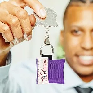 Ever Ready First Aid CPR Mask for Pocket or Key Chain CPR Emergency Face Shield with One-Way Valve Breathing Barrier for First Aid or AED Training 5 Count - Purple - man holding key