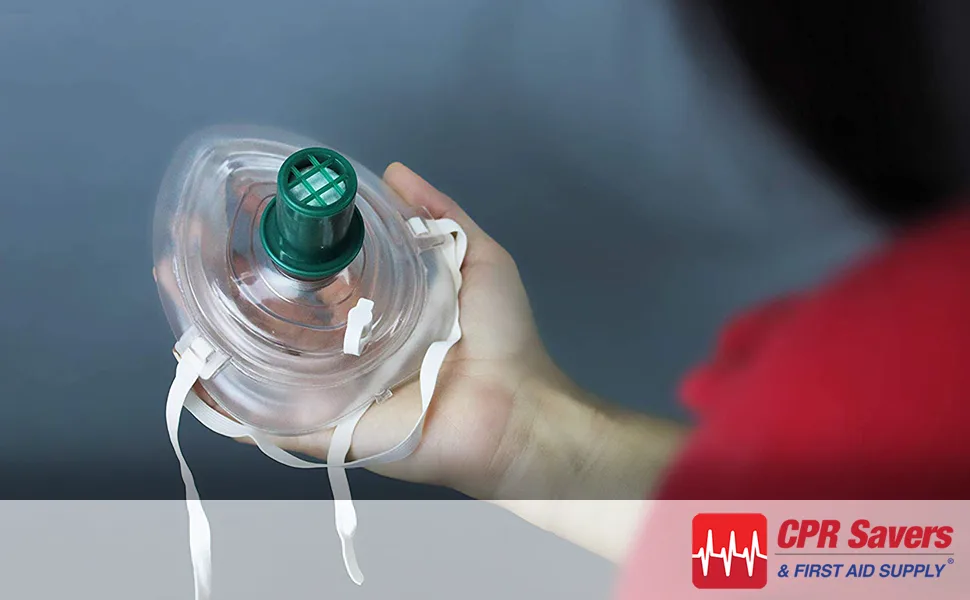 CPR Savers and First Aid Supply One-Way Disposable Training Valves for Micromask CPR Training Pack of 50 (1) - Someone holding cpr mask with cpr training valve inserted in it.