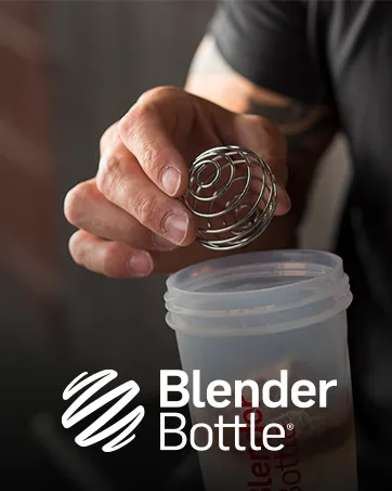 BlenderBottle Classic V2 Shaker Bottle Perfect for Protein Shakes and Pre Workout 32-Ounce Black Black 32-Ounce Bottle - hand putting blender whisk ball into blender bottle cup with protein powder