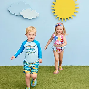 Mud Pie Children's Grandma Cuddler Teether - two kids running in swimwear