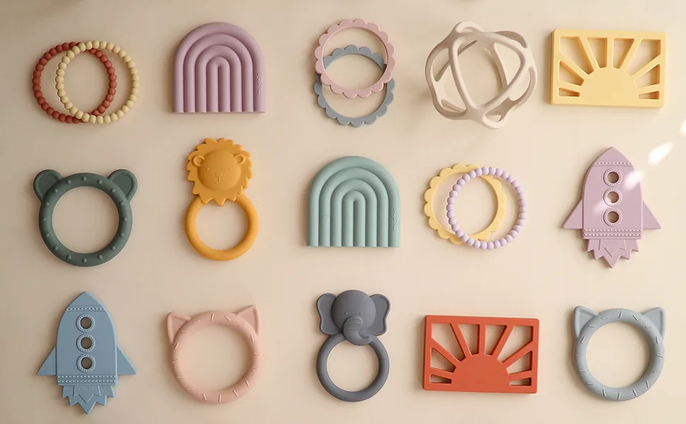 mushie Flower Teether Bracelet | 3-Pack (Cambridge Blue/Clementine/Natural) - Mushie Bracelet Teethers | Lifestyle Bracelets Flatlay